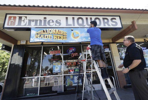 The California Lottery says last month's $543 million Mega Millions jackpot was won by 11 members of an office pool that played on a whim. A Lottery statement on Aug. 3, 2018. (AP Photo/Jeff Chiu, File)