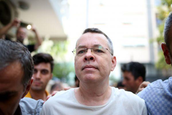 Pastor Andrew Craig Brunson, escorted by Turkish plainclothes police officers as he arrives at his house in Izmir on July 25, 2018. (Stringer/AFP/Getty Images)