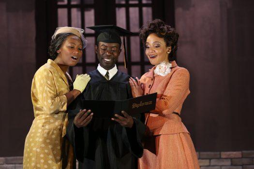 Anita Welch (L) and Stephanie Umoh surround Charlie Hudson III, who plays Ernest Green, the first African-American student to graduate from Central High School. (Carol Rosegg)
