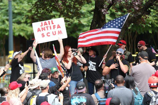In this June 30, 2018, file photo, the Patriot Prayer group holds a rally and march in Portland, Ore., amid a protest by Antifa groups. Portland is bracing for what could be another round of violent clashes Saturday, Aug. 4, 2018. (Mark Graves/The Oregonian via AP, file)