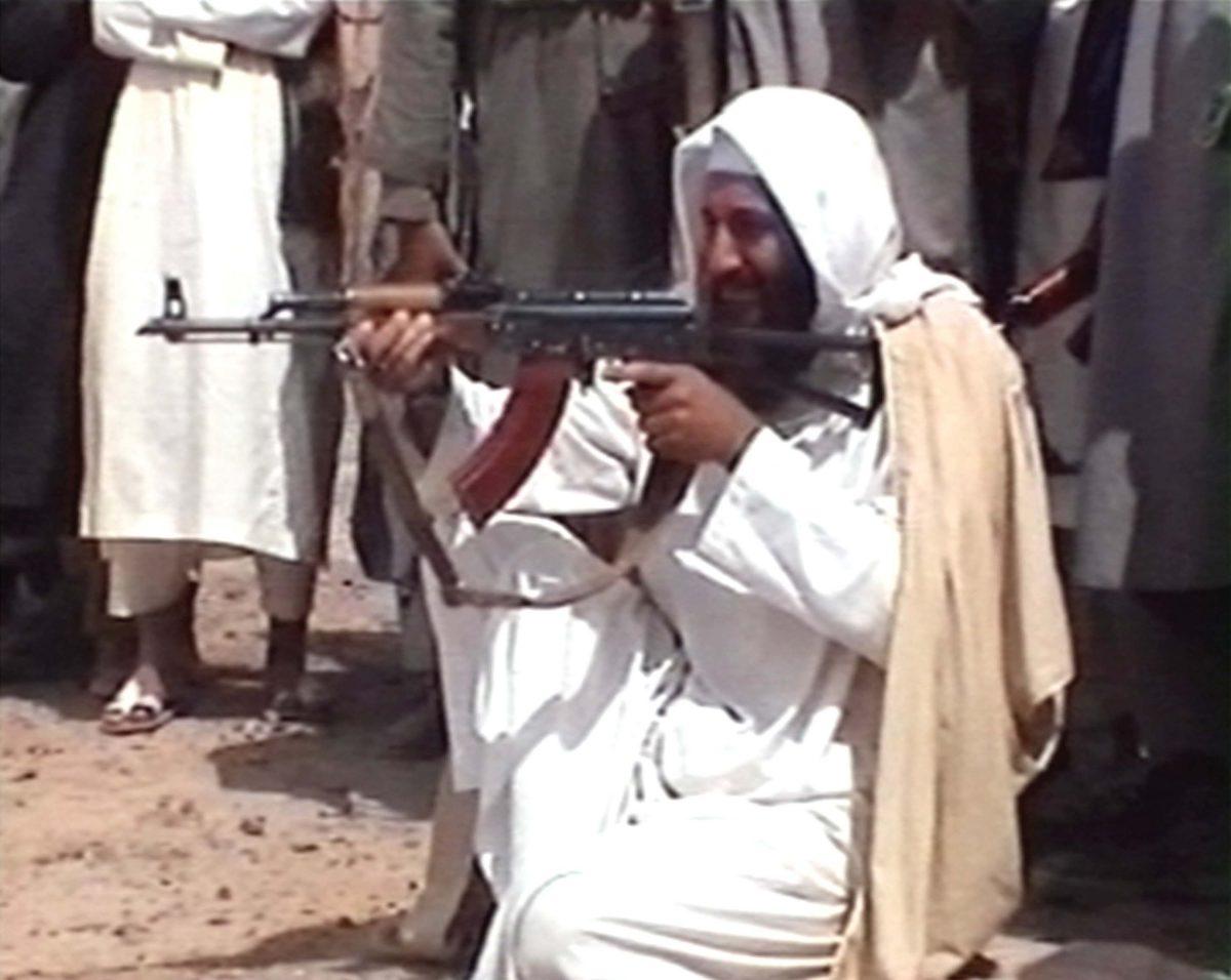 Saudi-born Osama bin Laden is seen aiming a weapon in this undated photo from Al-Jazeera TV. (Al-Jazeera/Getty Images)