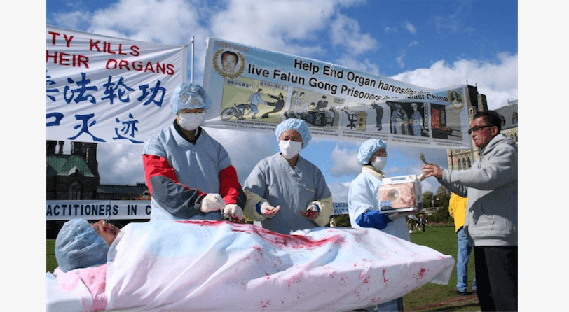 A re-enactment of organ harvesting in China on Falun Gong practitioners, during a rally in Ottawa, Canada, 2008. (The Epoch Times)