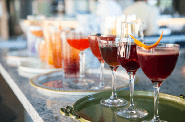 A lineup of cocktails at The Gray Canary, whose bar aims to reduce waste through the use of kitchen discards such as pecan shells and corn husks. (Courtesy of The Gray Canary)