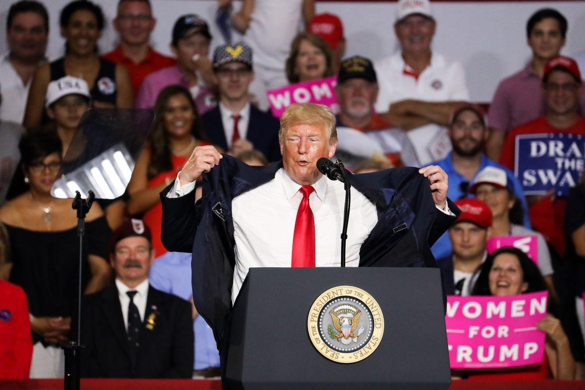 President Donald Trump mentions the sweltering temperature inside the rally venue, saying “If you can take it, I can take it,” in Lewis Center, Ohio, on Aug. 4, 2018. (Charlotte Cuthbertson/The Epoch Times)