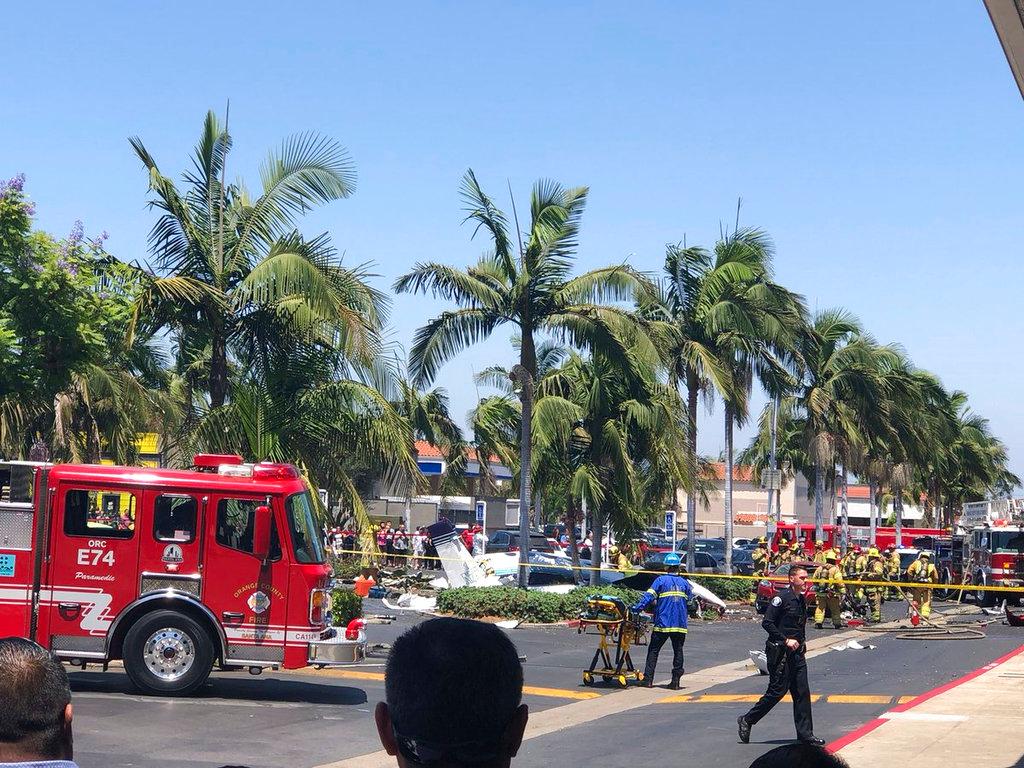 A  twin-engine aircraft crashed near the South Coast Plaza shopping center in Santa Ana, Calif., Sunday, Aug. 5, 2018. Federal Aviation Administration spokeswoman Arlene Salac said the twin-engine Cessna 414 declared an emergency before crashing about a mile from Orange County's John Wayne Airport. (Eddie Ponsdomenech/PonsMedia via AP)