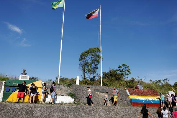 FILE PHOTO: People stand at the border with Venezuela, seen from the Brazilian city of Pacaraima, Roraima state, Brazil November 16, 2017. Picture taken November 16, 2017. (Reuters/Nacho Doce)