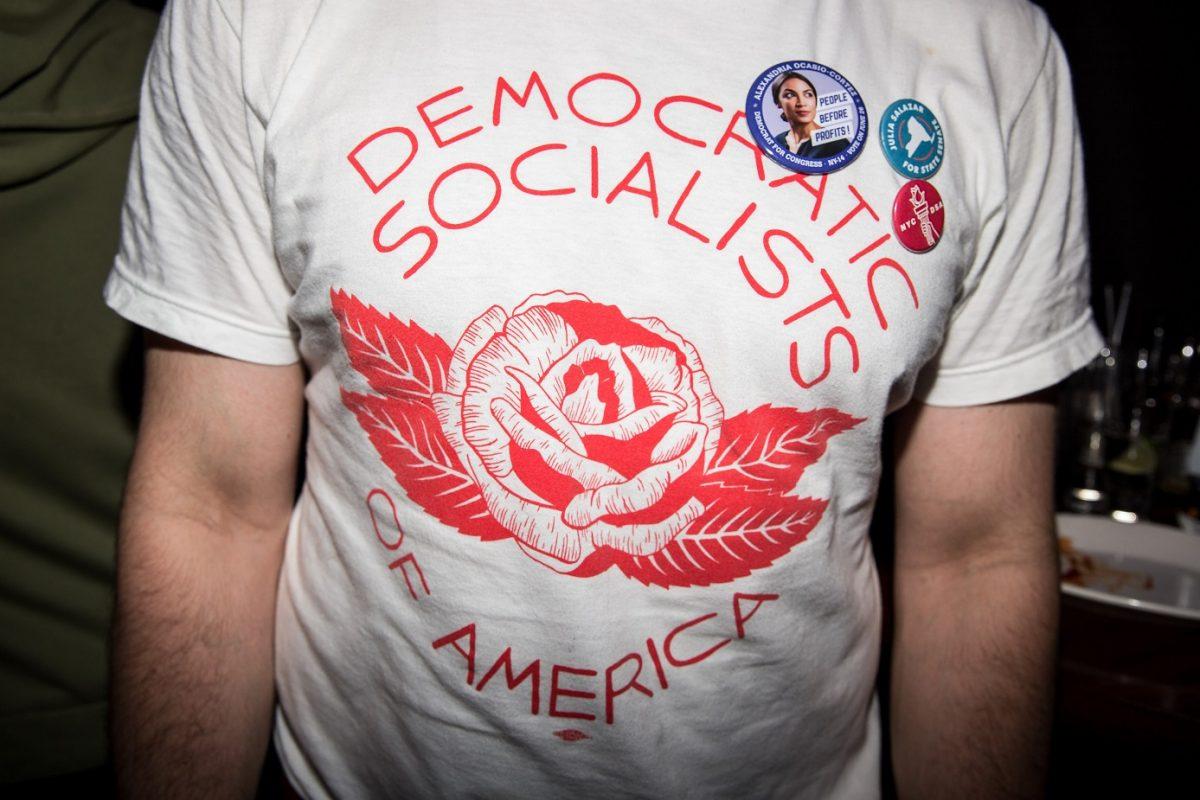 A young man wears a Democrat Socialists of America t-shirt at the victory party for socialist Alexandria Ocasio-Cortez, who has just become the Democratic candidate for New York's 14th congressional district, on June 26, 2018 in New York City. (Scott Heins/Getty Images)