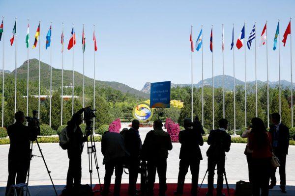 Journalists take pictures outside the venue of a summit at the One Belt, One Road Forum in Beijing on May 15, 2017. (Thomas Peter-Pool/Getty Images)