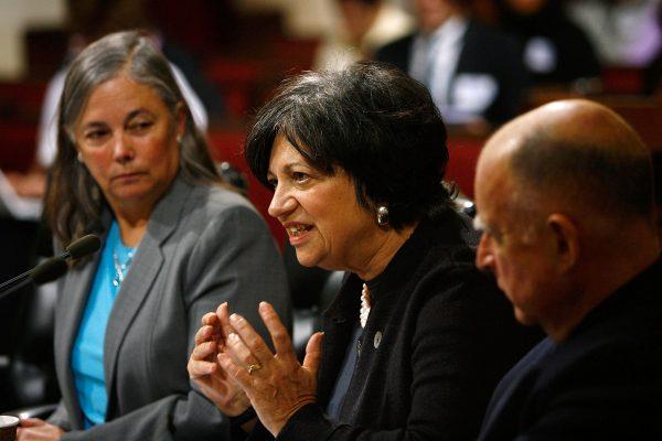 California Air Resources Board Chair Mary Nichols (C) speaks with Fran Pavley (L), original author of the Clean Car Act and California Attorney General Jerry Brown (R) listen at a US Senate Committee on Environment and Public Works public field briefing in Los Angeles on Jan. 10, 2008. (Photo by David McNew/Getty Images)
