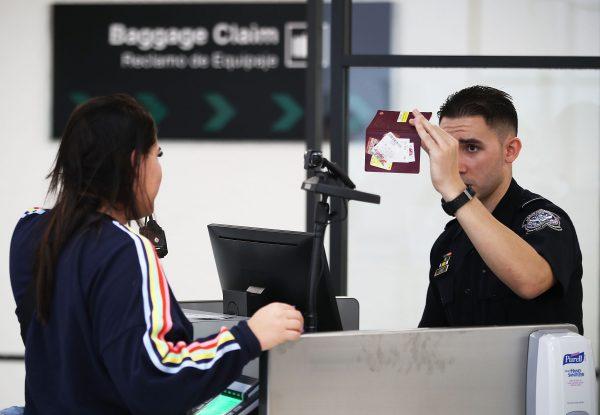 A U.S. Customs and Border Protection officer uses facial recognition technology to screen a traveler entering the United States at Miami International Airport in Miami, Fla., on Feb. 27, 2018. (Joe Raedle/Getty Images)