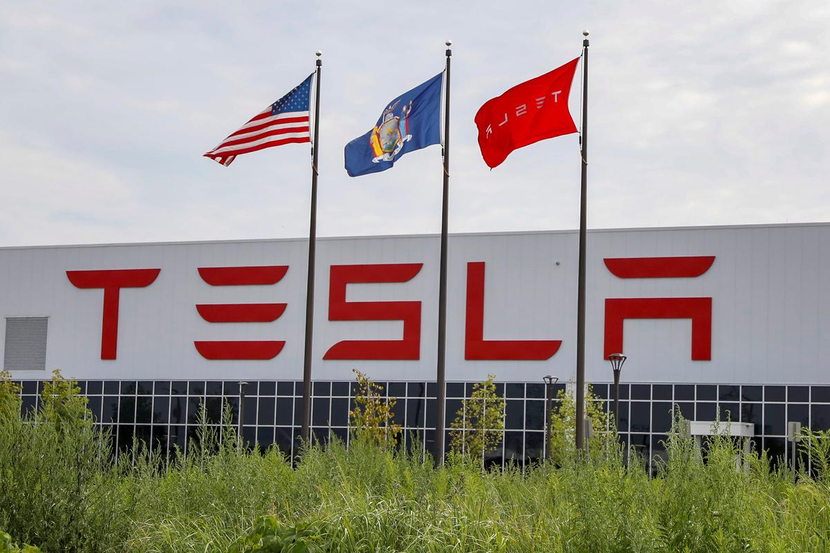 Flags fly over the Tesla Inc. Gigafactory 2, which is also known as RiverBend, a joint venture with Panasonic to produce solar panels and roof tiles in Buffalo, N.Y., on Aug. 2, 2018. (Brendan McDermid/Reuters)