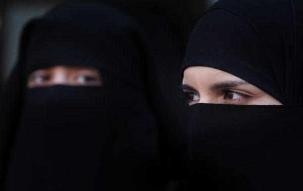 Two women wearing Islamic niqab veils stand outside the French Embassy during a demonstration in London on April 11, 2011. (Peter Macdiarmid/Getty Images)
