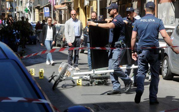 Italian police work on the site where mafia boss Giuseppe Dainotti, 67, was gunned down by two killers while riding his bike on May 22, 2017, in Via d'Ossuna in Palermo, Sicily. (Alessandro Fucarini/AFP/Getty Images)