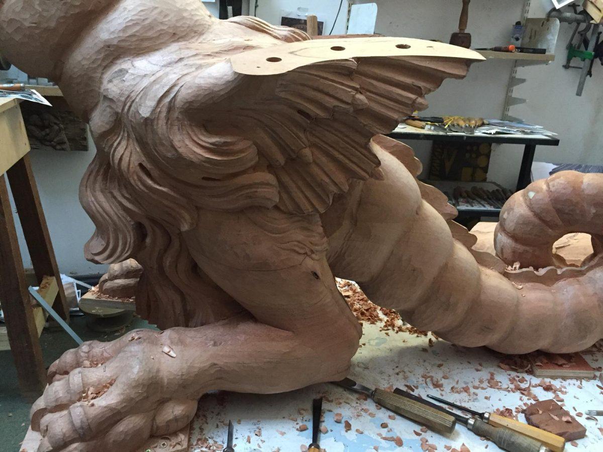 The strong musculature in the dragon's leg is captured through the skilled workmanship of master carvers Robert Randall and Ashley Sands. (Sands & Randall)