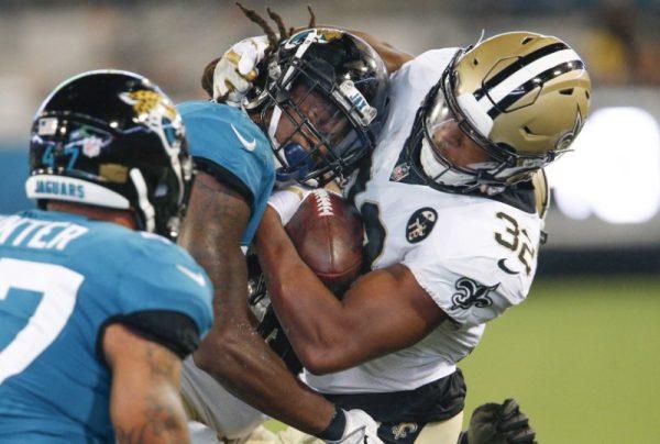 Aug. 9, 2018; Jacksonville, Fla; New Orleans Saints running back Jonathan Williams is hit by Jacksonville Jaguars defensive back Jarrod Wilson after a catch during the second half. (Reinhold Matay—USA TODAY Sports)