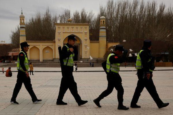A police patrol walk in front of the Id Kah Mosque in the old city of Kashgar, Xinjiang Uighur Autonomous Region, China, in this file photo. (Reuters/Thomas Peter)