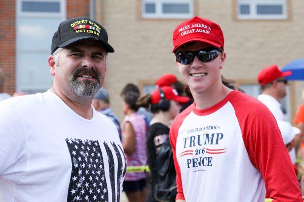 Mike Harris (L) and his son Jake Harris line up for a Make America Great Again rally in Lewis Center, Ohio, on Aug. 4, 2018. (Charlotte Cuthbertson/The Epoch Times)