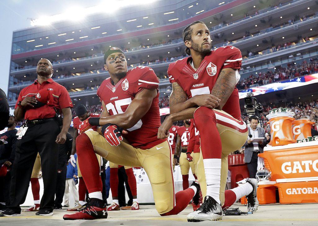 San Francisco 49ers safety Eric Reid (35) and quarterback Colin Kaepernick (7) kneel during the national anthem before an NFL football game against the Los Angeles Rams in Santa Clara, California on Sept. 12, 2016. (AP Photo/Marcio Jose Sanchez)