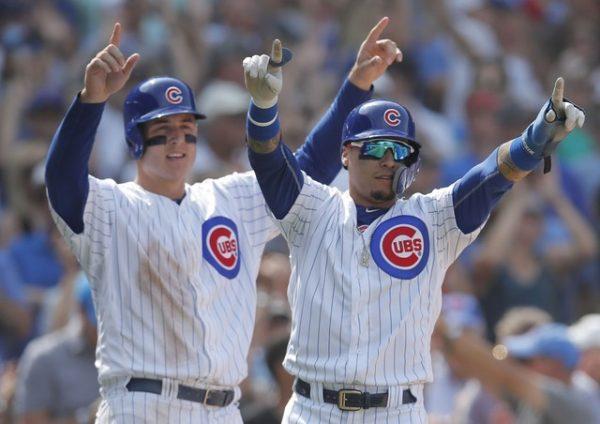 Chicago Cubs first baseman Anthony Rizzo, and Chicago Cubs second baseman Javier Baez celebrate after scoring two runs against the Washington Nationals during the sixth inning at Wrigley Field. (Jim Young—USA Today Sports)