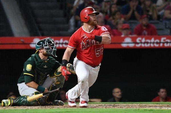 Los Angeles Angels right fielder Kole Calhoun hits a two-run home run in the third inning against the Oakland Athletics. (Richard Mackson—USA Today Sports)
