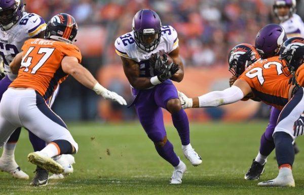 Minnesota Vikings running back Roc Thomas carries the ball between the tackles of Denver Broncos linebacker Josey Jewell and defensive end Adam Gotsis in the first quarter. (Ron Chenoy/USA Today Sports)