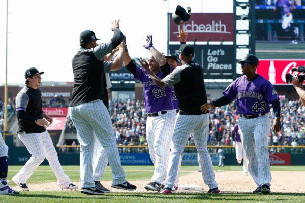 Colorado Rockies catcher Chris Iannetta celebrates with teammates after his bases loaded walk off walk RBI in the ninth inning against the Los Angeles Dodgers. (Isaiah J. Downing/USA Today Sports)