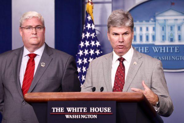 John Byrd (R), director of the Defense POW/MIA Accounting Agency's Central Identification Laboratory, talks about the repatriated remains of U.S. servicemen killed in North Korea, as Timothy McMahon, director of Forensic Services at the Armed Forces Medical Examiner's DNA Identification Lab, looks on, during a White House press briefing in Washington on Aug. 14, 2018. (Samira Bouaou/The Epoch Times)