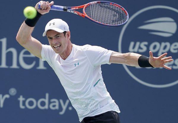 Andy Murray, of Great Britain, returns to Lucas Pouille, of France, in the first round at the Western and Southern Open, Monday, Aug. 13, 2018, in Mason, Ohio. (AP/John Minchillo)