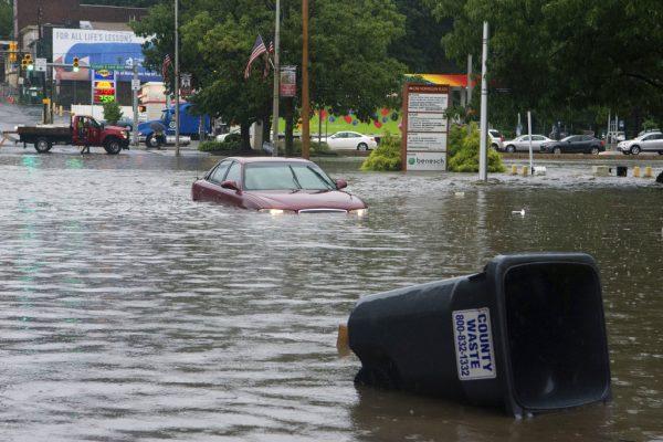 A car sits submerged at an intersection in Pottsville, Pa., on Monday, Aug. 13, 2018. (David McKeown/Republican-Herald/AP)