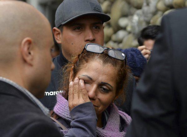 A woman cries as she arrives to find out news of soccer fans killed in a bus crash outside the morgue in Cuenca, Ecuador, Monday, Aug. 13, 2018. At least 12 fans of Ecuadorean football team Barcelona were killed and 30 injured when the bus they were traveling in after a match against Deportivo Cuenca overturned on Sunday. (AP/Javier Ramirez)