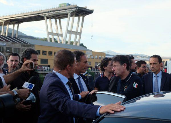 Italian Prime Minister Giuseppe Conte (2ndR) visits the site where a section of the Morandi motorway bridge collapsed in Genoa on Aug. 14, 2018. (Andrea Leoni/AFP/Getty Images)
