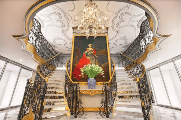 The lobby of the S.S. Maria Theresa features a marble staircase, a Venetian chandelier, and a portrait of the empress. (Courtesy of Uniworld River Cruises)