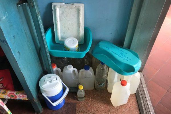 Containers filled with water are seen at the Central University of Venezuela (UCV) hospital in Caracas, Venezuela on Aug. 14, 2018. (Reuters/Marco Bello)