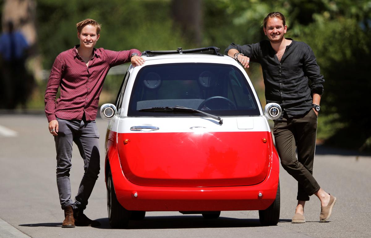 Chief Operating Officer Oliver (L) and his brother Chief Marketing Officer Merlin Ouboter of Swiss Microlino AG pose beside an electric-powered Microlino car in Kuesnacht, Switzerland on July 13, 2018. (Reuters/Arnd Wiegmann)