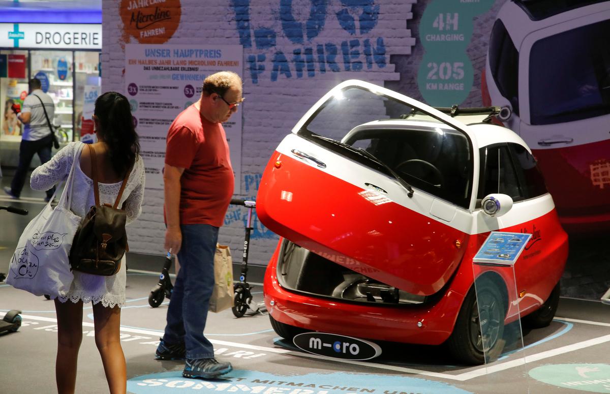 An electric-powered Microlino car built by Swiss Microlino AG is displayed in a shopping mall in Zurich, Switzerland on July 17, 2018. (Reuters/Arnd Wiegmann)