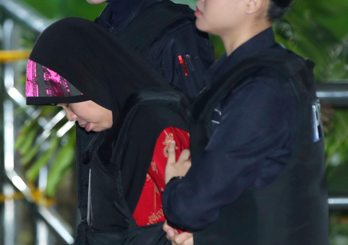 Indonesian Siti Aisyah, left, arrives at court for allegedly killing Kim Jong Nam, the North Korean leader Kim Jong Un's half-brother. (AP Photo/Jeffrey Ong)