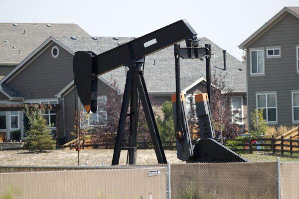 A pump jack sits near the home where a pregnant woman and her two daughters lived. (AP Photo/David Zalubowski)