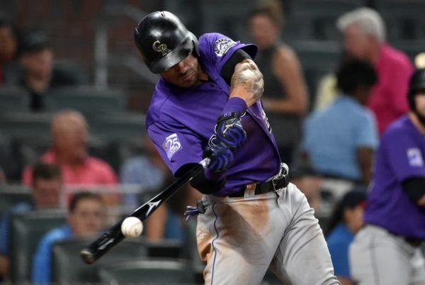 Colorado Rockies first baseman Ian Desmond hits an RBI against the Atlanta Braves during the eighth inning. (Adam Hagy/USA Today Sports)