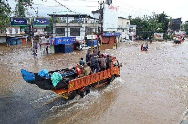 A supply truck transporting boats to flooded areas moves through a water-logged road in Aluva in the southern state of Kerala, India on August 18, 2018. (Sivaram V/REUTERS)