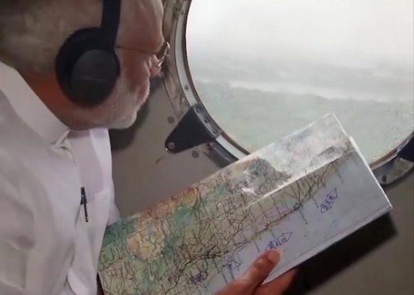 In this image from video, Indian Prime Minister Narendra Modi looks out from inside a helicopter during an aerial survey of flood affected areas in Kerala, southern India, on Aug. 18, 2018. (Doordarshan via AP)