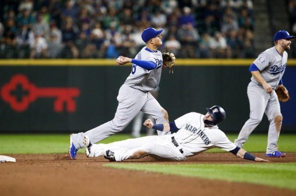 Los Angeles Dodgers shortstop Manny Machado attempts a double play against Seattle Mariners right fielder Mitch Haniger during the tenth inning. (Joe Nicholson/USA Today Sports)