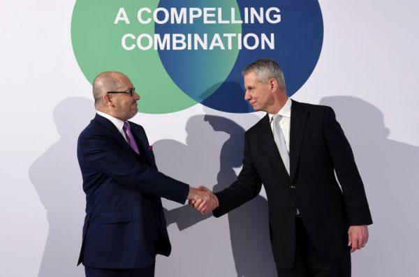 CEO of German company Linde, Aldo Belloni and CEO of US company Praxair, Steve Angel, shake hands ahead of a news conference in Munich, Germany, on June 2, 2017. (Christof Stache/AFP/Getty Images)