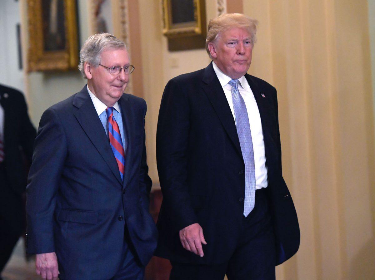 Then-U.S. President Donald Trump and U.S. Senate Majority Leader Mitch McConnell make their way to a Senate Republican policy lunch at the U.S. Capitol in Washington on May 15, 2018. (Saul Loeb/AFP/Getty Images)