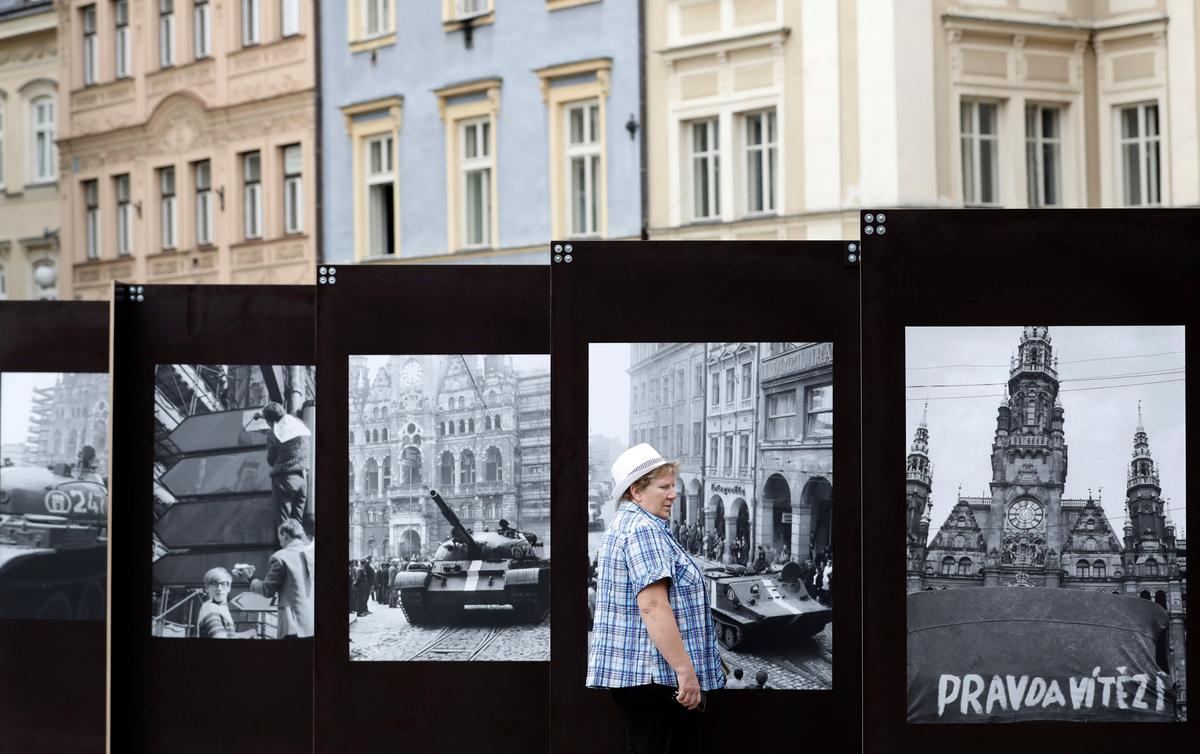 A woman looks at a pictures, commemorating the 50th anniversary of the Soviet-led invasion into former Czechoslovakia on Aug. 21, 2018. (Reuters/David W Cerny)