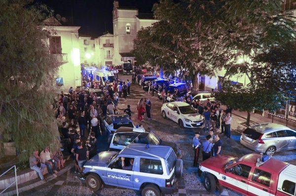 Rescuers and citizens wait in the central square of Civita, a village in the Italy's southern Calabria region, on Aug. 20, 2018. (Kontrolab/AFP/Getty Images)