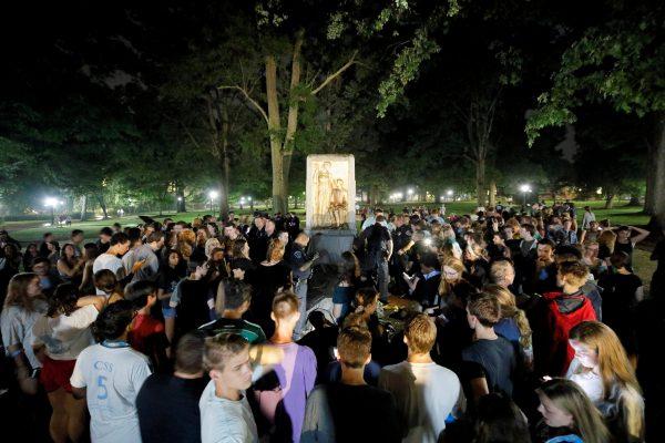 Students and protesters surround a plinth where the toppled statue of a Confederate soldier nicknamed Silent Sam once stood on the University of North Carolina campus after a demonstration for its removal in Chapel Hill, N.C., on Aug. 20, 2018. (Jonathan Drake/Reuters)