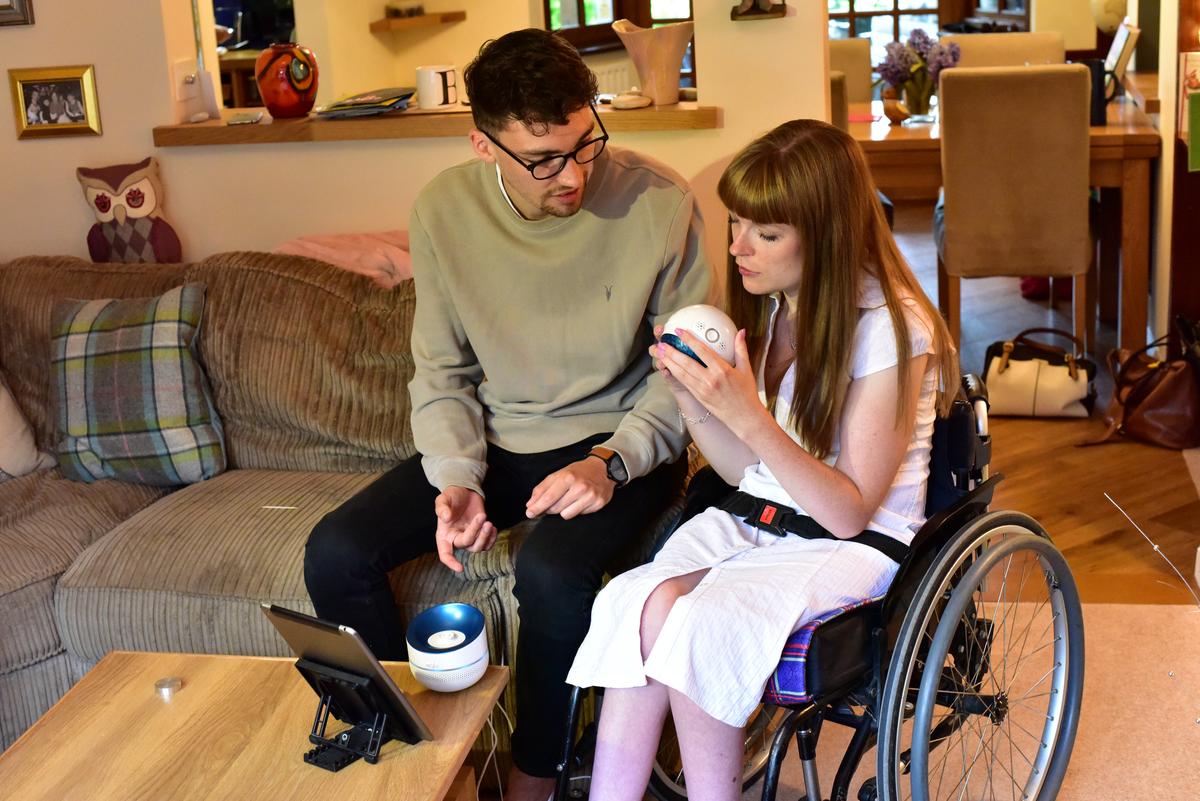 Designer Billy Searle shows his sister Jess how to use 'Mylo', a spherical games controller he has built to help people with disabilities to improve their mental fitness and dexterity, in London, Britain on Aug. 9, 2018. (Reuters/Matthew Stock)