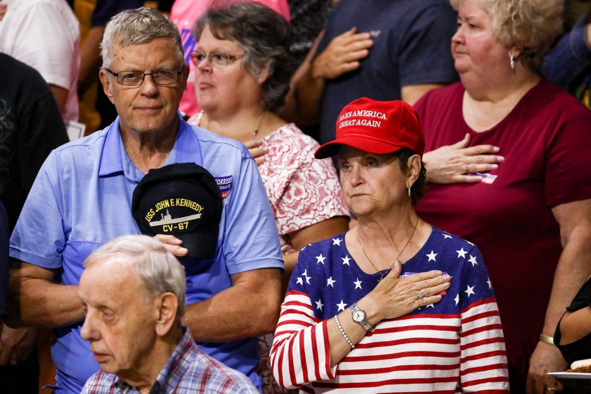 The audience during the Pledge of Allegience at a Make America Great Again rally in Charleston, W. Va., on Aug. 21, 2018. (Charlotte Cuthbertson/The Epoch Times)