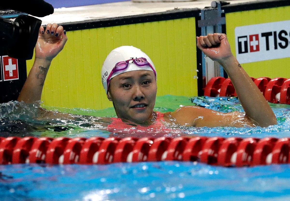 China's Liu Xiang celebrates after winning the women's 50m backstroke final during the swimming competition at the 18th Asian Games in Jakarta, Indonesia, Tuesday, Aug. 21, 2018. (AP Photo/Lee Jin-man)