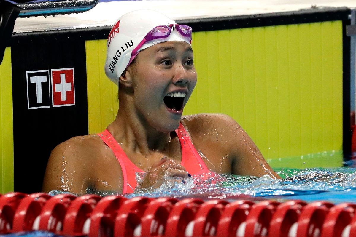 China's Liu Xiang celebrates after winning the women's 50m backstroke final during the swimming competition at the 18th Asian Games in Jakarta, Indonesia on Aug. 21, 2018. (AP/Lee Jin-man)